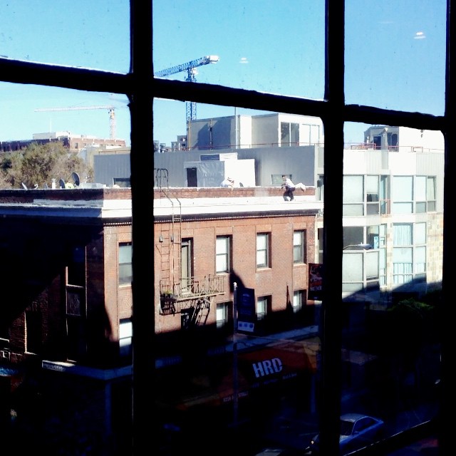 There's a dude doing some pop and lock on the roof ledge across from us...